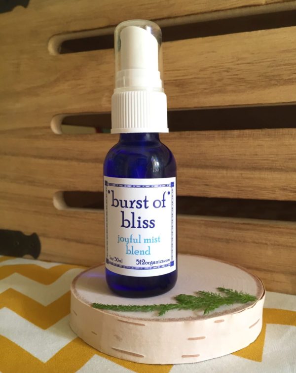 512organics bottle of 1 oz Burst of Bliss essential oils misting spray with wood background